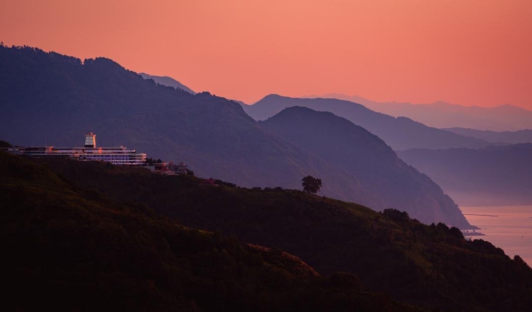 Litz wellness resort perched on forested mountains at dusk